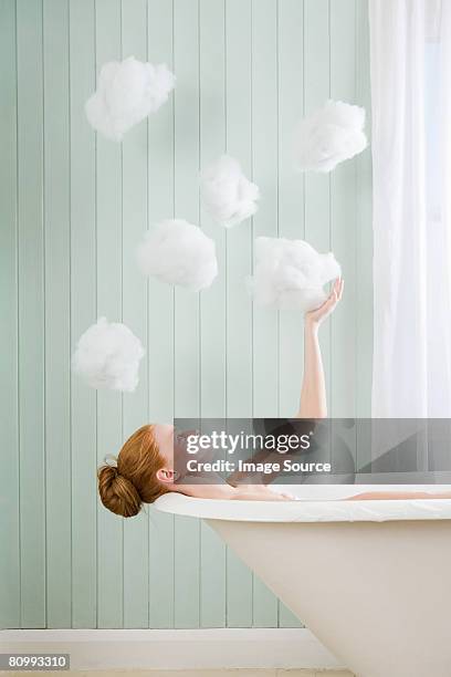 a woman touching a cloud - woman in bathroom stockfoto's en -beelden