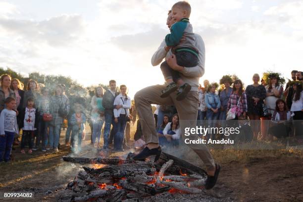 Ukrainians jump over bonfires, during celebration the traditional Slavic celebrations of Ivana Kupala at the National Museum of Folk Architecture and...