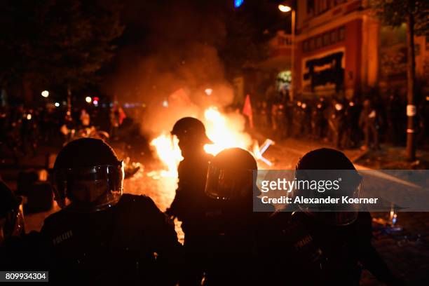 Riot police gather after protesters erected burning barricades in front of the Rote Flora left-wing centre after the "Welcome to Hell" protest march...