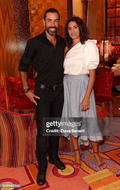 Robert Pires and Jessica Lemarie-Pires attend a private dinner to celebrate the Havaianas Art Auction in aid of Women for Women International curated...