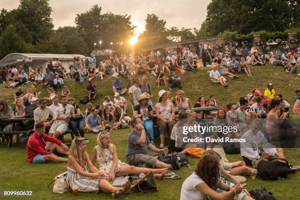 Spectators enjoy the atmosphere at Murray Mound by the end of day four of the Wimbledon Lawn Tennis Championships at the All England Lawn Tennis and...
