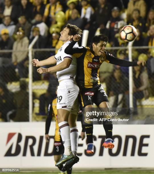 Diego Wayar of Bolivia's The Strongest vies for the ball with Nicolas Diego Aguirre of Argentina's Lanus during their Copa Libertadores match at...
