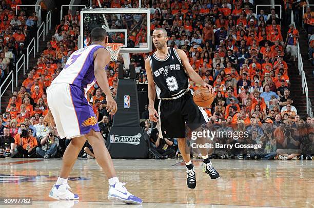 Tony Parker of the San Antonio Spurs moves the ball up court against Boris Diaw of the Phoenix Suns in Game Three of the Western Conference...
