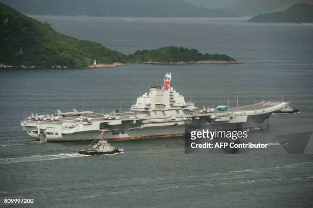 China's aircraft carrier Liaoning sails past Lamma island as it arrives in Hong Kong on July 7, 2017. China's national defence ministry had said the...