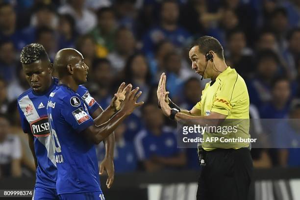 Colombia's referee Wilson Lamouroux speaks with Ecuador's Emelec player Oscar Bagui during their 2017 Copa Libertadores football match at George...
