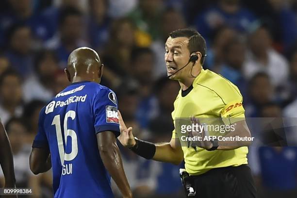 Colombia's referee Wilson Lamouroux speaks with Ecuador's Emelec player Oscar Bagui during their 2017 Copa Libertadores football match at George...