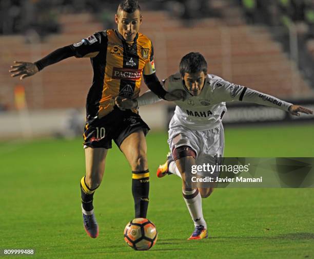 Pablo Escobar of The Strongest and Matias Rojas of Lanus fight for the ball during a first leg match between The Strongest and Lanus as part of Copa...