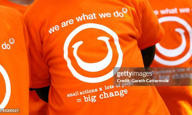 Pupils from Godwin Junior School, wear T-shirts printed with the slogan "We Are What We Do... Small actions x lots of people = big change" during a...