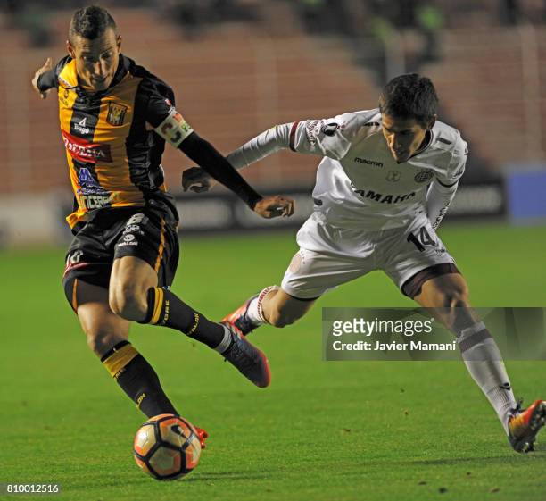 Pablo Escobar of The Strongest and Matias Rojas of Lanus fight for the ball during a first leg match between The Strongest and Lanus as part of Copa...