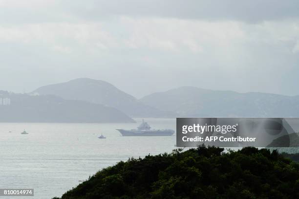China's aircraft carrier, the Liaoning, sails through the Lamma Channel as it arrives in Hong Kong territorial waters on July 7, 2017. China's...