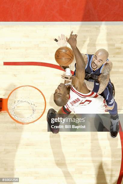 Carlos Boozer of the Utah Jazz puts a shot up over Dikembe Mutombo of the Houston Rockets in Game Five of the Western Conference Quarterfinals during...