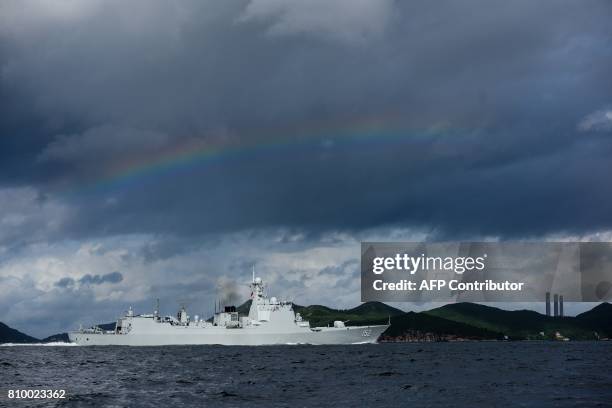 Rainbow is seen as the Jinan , a destroyer of China's People's Liberation Army Navy , provides an escort ahead of the Liaoning aircraft carrier into...