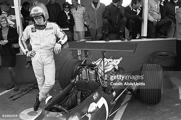 Derek Bell leans on a teammate's Ferrari 312 before the United States Grand Prix held at Watkins Glen, New York on October 6, 1968.