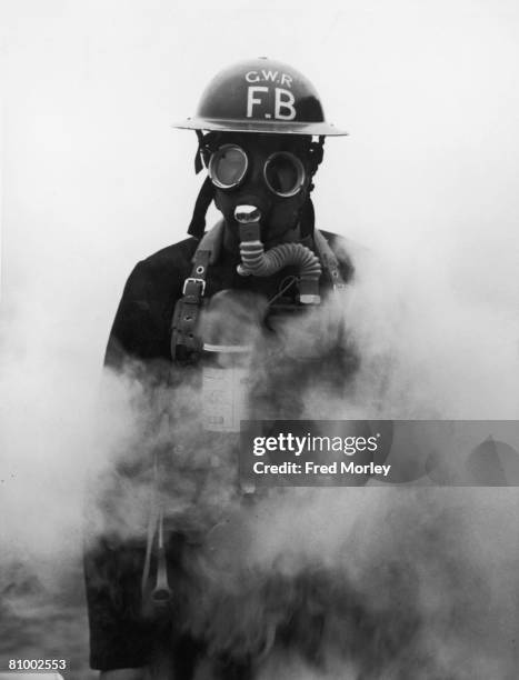 Member of the GWR contamination squad prepares for the possibility of gas warfare, 10th December 1941. The GWR now has special railway cleansing vans...