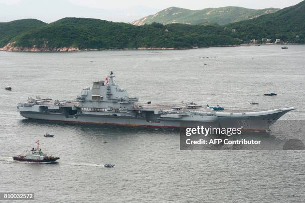 China's aircraft carrier Liaoning sails past Lamma island as it arrives in Hong Kong on July 7, 2017. China's national defence ministry had said the...