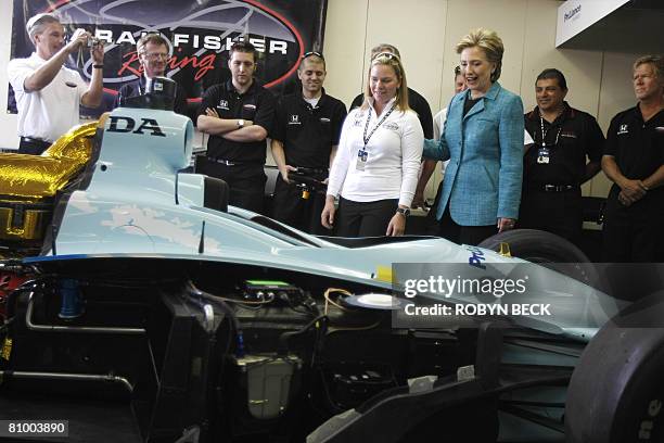 Democratic presidential hopeful New York Senator Hillary Clinton looks at the race car of driver Sarah Fisher during a campaign stop at the...