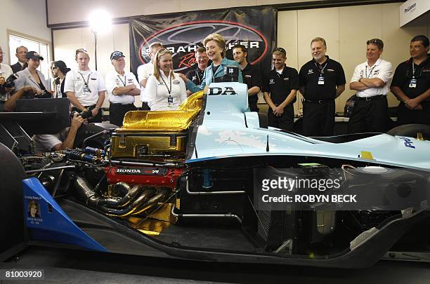Democratic presidential hopeful New York Senator Hillary Clinton looks at the race car of driver Sarah Fisher during a campaign stop at the...