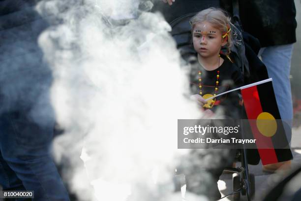 Young girl watches the smoking ceremony at the 2017 NAIDOC March on July 7, 2017 in Melbourne, Australia. The march was organised to call for a day...