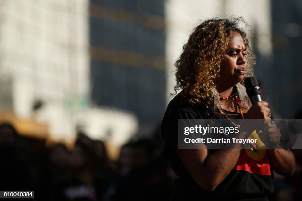 Speaker entertains the crowd as they sit down at the intersection of Flinders Street and Swanston Street during the 2017 NAIDOC March on July 7, 2017...