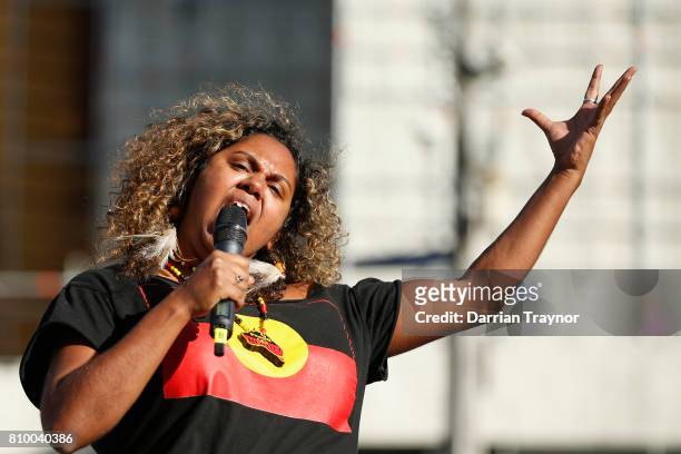 Speaker entertains the crowd as they sit down at the intersection of Flinders Street and Swanston Street during the 2017 NAIDOC March on July 7, 2017...