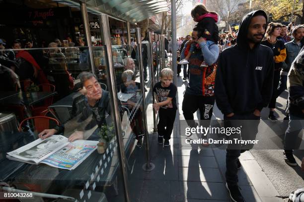 Man looks on as the the 2017 NAIDOC March heads down Swanston Street on July 7, 2017 in Melbourne, Australia. The march was organised to call for a...