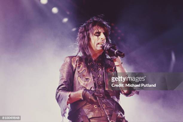 American rock singer Alice Cooper performing on stage in the late 1980's.
