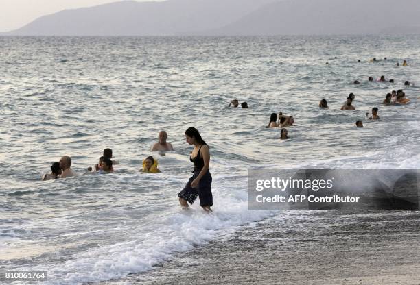 Syrians spend time on the shores of the Mediterranean Sea in Wadi Qandil north of the seaside city of Latakia on July 6, 2017. / AFP PHOTO / JOSEPH...