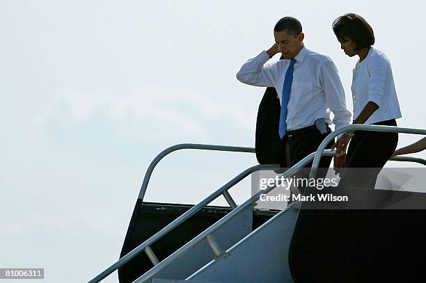 Democratic presidential hopeful Sen. Barack Obama and his wife Michelle Obama walk off the campaign plane after arriving in North Carolina May 6,...