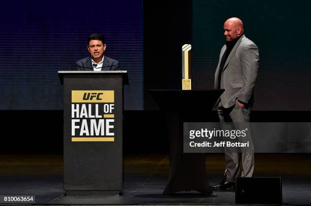 Former UFC matchmaker Joe Silva speaks to the crowd as UFC President Dana White stands on stage during the UFC Hall of Fame 2017 Induction Ceremony...