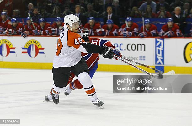 Daniel Briere of the Philadelphia Flyers shoots as he is defended by Bryan Smolinski of the Montreal Canadiens during Game Five of the Eastern...