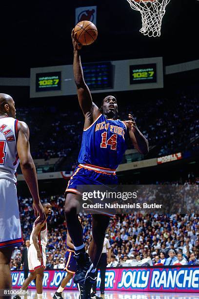 Anthony Mason of the New York Knicks shoots a layup against Derrick Coleman of the New Jersey Nets in Game Three of the Eastern Conference...