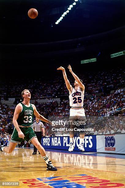 Mark Price of the Cleveland Cavaliers shoots a jump shot over Larry Bird of the Boston Celtics in Game One of the Eastern Conference Semifinals...