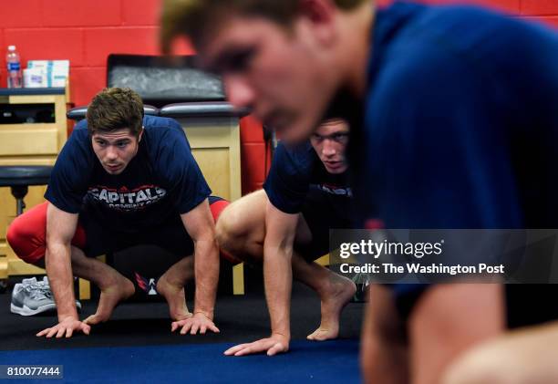 Washington Capitals defensive prospect Connor Hobbs, left, participates in a yoga session during the Washington Capitals Development Camp at Kettler...