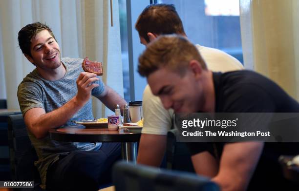 Washington Capitals defensive prospect Connor Hobbs jokes around with other attendees during breakfast before the day's activities during the...