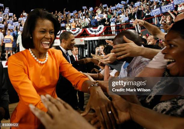 Michelle Obama and her husband Democratic presidential hopeful Sen. Barack Obama greet the crowd at the North Carolina State University arena May 6,...