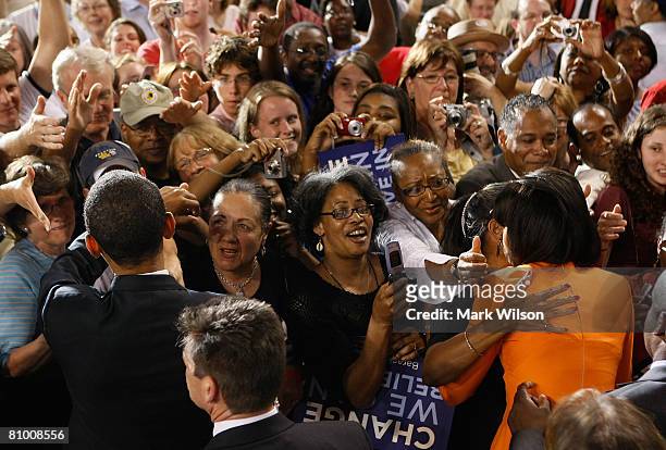 Democratic presidential hopeful Sen. Barack Obama and his wife Michelle Obama greet supporters after speaking during a rally at the North Carolina...