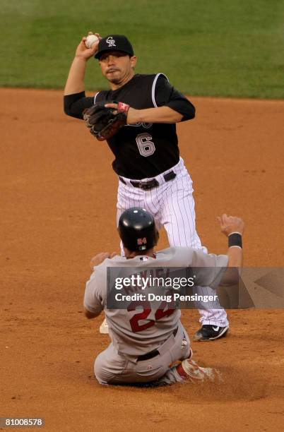 Shortstop Omar Quintanilla of the Colorado Rockies turns a double play over Rick Ankiel of the St. Louis Cardinals on a ball hit by Yadier Molina in...