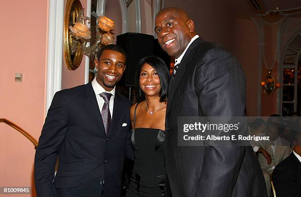 Former NBA player Earvin 'Magic' Johnson, his wife Cookie and their son Andre Johnson attend the USA TODAY Hollywood Hero honoring Magic Johnson at...