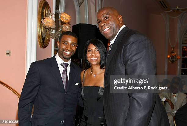 Former NBA player Earvin 'Magic' Johnson, his wife Cookie and their son Andre Johnson attend the USA TODAY Hollywood Hero honoring Magic Johnson at...