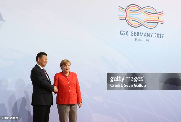 German Chancellor Angela Merkel greets Chinese President Xi Jinping upon his arrival for the first day of the G20 economic summit on July 7, 2017 in...