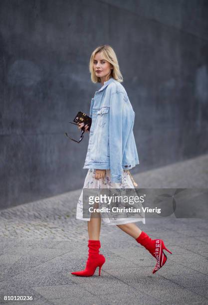 Lisa Hahnbueck wearing Zimmermann dress, a denim jeans jacket Off White, red vintage Chanel belt bag, red Balenciaga x Colette Knife boots during the...
