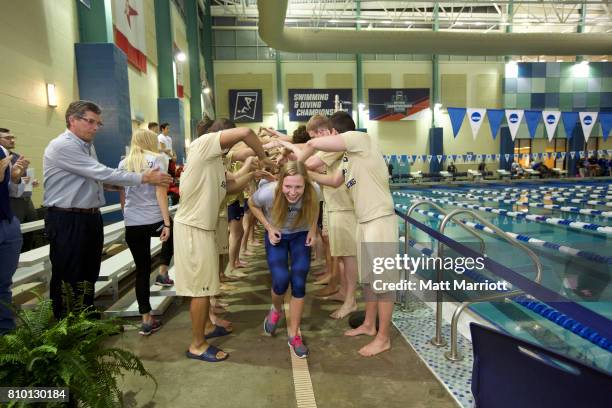 The Wingate University team receives their third place trophy during the Division II Men's and Women's Swimming & Diving Championship held at the...