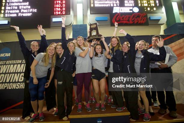 The Wingate University team receives their third place trophy during the Division II Men's and Women's Swimming & Diving Championship held at the...