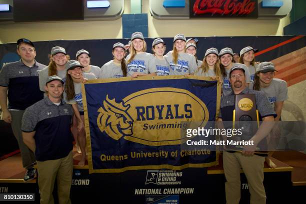 The Queens University team receives their first place trophy during the Division II Men's and Women's Swimming & Diving Championship held at the...
