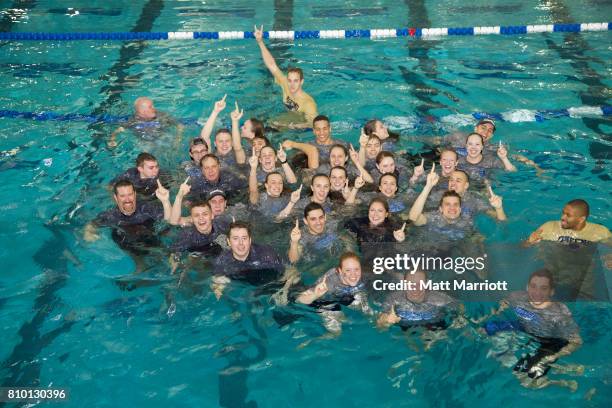 The Queens University team celebrates their first place finish during the Division II Men's and Women's Swimming & Diving Championship held at the...