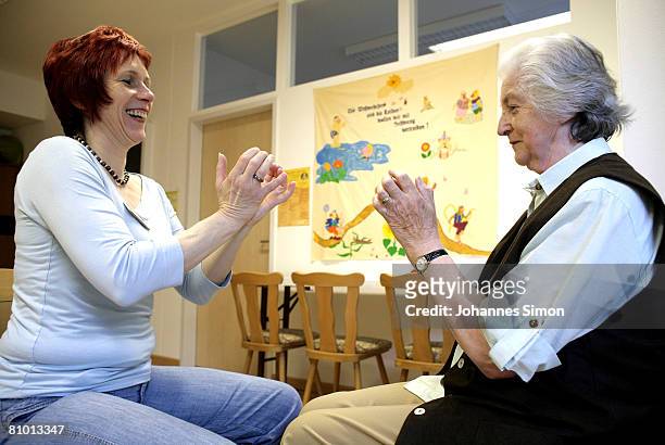 Anna Pappenberger , inhabitant of the St.Michael Zentrum, residential home for the elderly, and therapist Elke Richter are seen during a physical...
