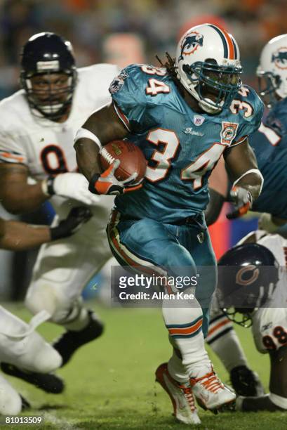 Ricky Williams of the Miami Dolphins runs with the ball during the game against the Chicago Bears on December 9, 2002 at Pro Player Stadium in Miami,...
