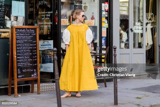 Vika Gazinskaya wearing a yellow dress outside Valentino during Paris Fashion Week - Haute Couture Fall/Winter 2017-2018 : Day Four on July 5, 2017...