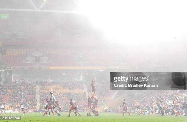 Players compete at the lineout as a blanket of fog can be seen during the round 16 Super Rugby match between the Reds and the Brumbies at Suncorp...