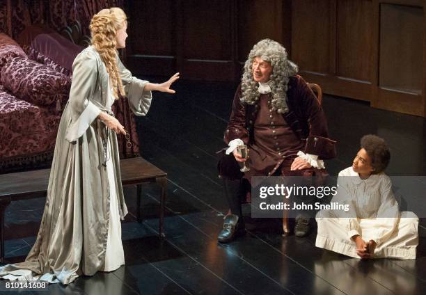 Romola Garai as Sarah Churchil, Richard Hope as Sydney Godolphin and Mark Jones as Jack Churchill perform on stage in a production of "Queen Anne" by...